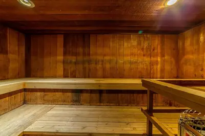 a wooden sauna with a bench in the middle at Adventure by Day Cozy Nights Family Alpine Condo in Mammoth Lakes