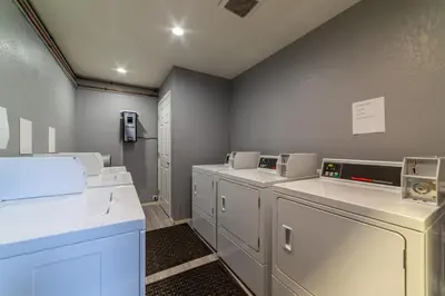 a laundry room with a row of washers and dryers at Adventure by Day Cozy Nights Family Alpine Condo in Mammoth Lakes