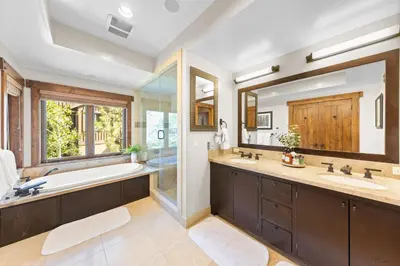 a bathroom with two sinks and a tub and a large mirror at 2 Luxury Adjacent Northstar Homes Walk to Lifts Private Hot Tubs in Truckee