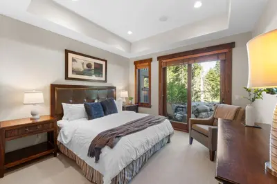 a bedroom with a bed and a desk and a chair at 2 Luxury Adjacent Northstar Homes Walk to Lifts Private Hot Tubs in Truckee