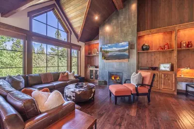 a living room with a couch and a fireplace at 2 Luxury Adjacent Northstar Homes Walk to Lifts Private Hot Tubs in Truckee