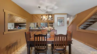 a dining room with a wooden table and chairs at Unique Northstar Cabin w Fireplace Minutes to Skiing Trails and Town Alpine Bend by AvantStay in Truckee