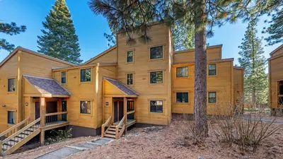 a large wooden house with trees in front of it at Unique Northstar Cabin w Fireplace Minutes to Skiing Trails and Town Alpine Bend by AvantStay in Truckee