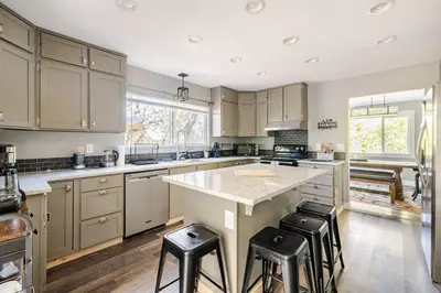 a kitchen with a large island with stools in it at Private Home,Ski HotTub,Firepit,Apple Hill,Tahoe in Placerville