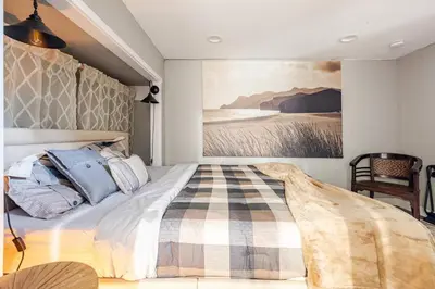a bedroom with a bed with a painting on the wall at Private Home,Ski HotTub,Firepit,Apple Hill,Tahoe in Placerville