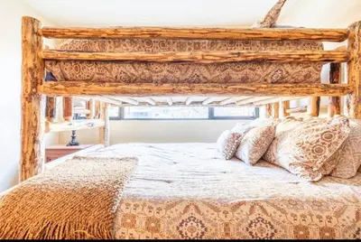 a bedroom with a bed with a wooden bed frame at Treehouse at Canyon Lodge Walk to Slopes in Mammoth Lakes