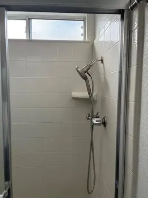 a shower with a shower head in a bathroom at Turlocks Little Palace in Turlock
