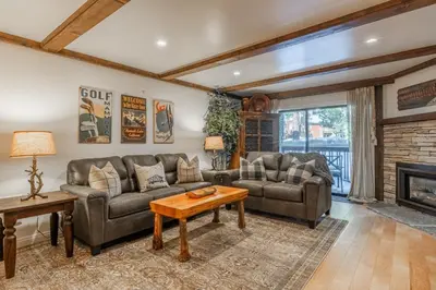 a living room with two couches and a fireplace at Summit 107 in Mammoth Lakes