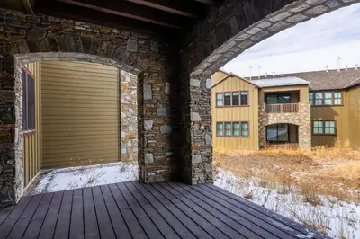 an open garage door with a building in the background at Mammoth Refuge Rustic Creekhouse Retreat in Mammoth Lakes