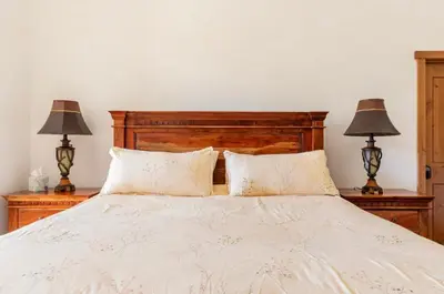 a bedroom with a white bed with two lamps at Stonegate 12 in Mammoth Lakes