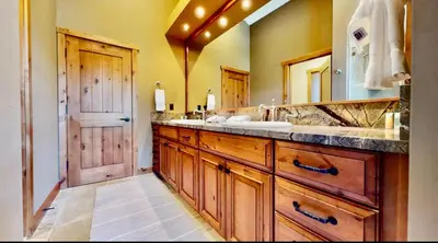 a bathroom with a sink and a large mirror at Stonegate 12 in Mammoth Lakes