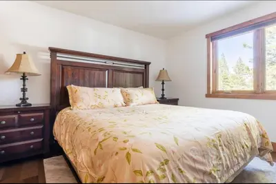 a bedroom with a large bed and a window at Stonegate 12 in Mammoth Lakes