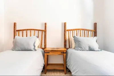 two beds with pillows and a table in a room at Stonegate 12 in Mammoth Lakes