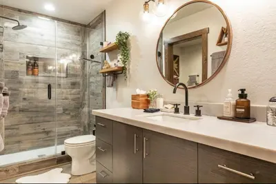 a bathroom with a sink and a shower with a mirror at Hidden Valley 33 in Mammoth Lakes