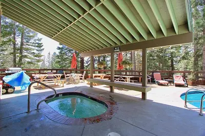 a patio with a hot tub on a deck at Hidden Valley 33 in Mammoth Lakes