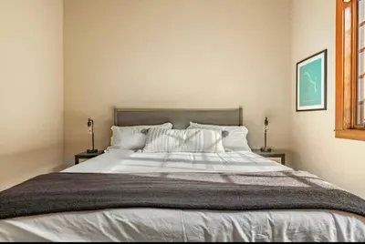 a bedroom with a large bed with white sheets and pillows at Magnolia Lodge 1 in Mammoth Lakes