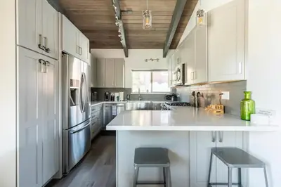 a kitchen with white cabinets and a large white counter at Mammoth Estates 233 in Mammoth Lakes