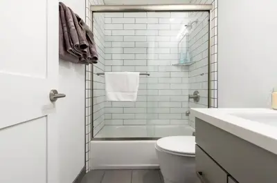 a white bathroom with a tub and a toilet at Mammoth Estates 233 in Mammoth Lakes