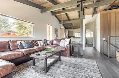 a living room with a brown couch and a table at Mammoth Estates 233 in Mammoth Lakes