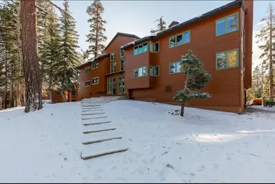 a building with snow in front of it at Alpine Glow Escape Big Windows & Views! in Mammoth Lakes