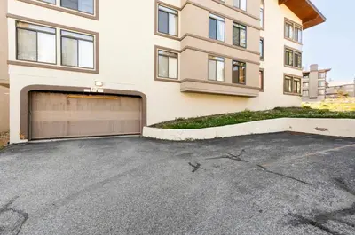 a parking lot in front of a building with a garage at Silver Bear 32 in Mammoth Lakes