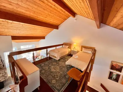 a bedroom with two beds and a wooden ceiling at Cozy Mammoth Ski Condo with Mtn Views and Hot Tub in Mammoth Lakes