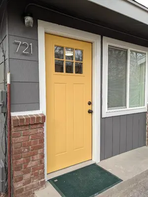 a yellow door on a house with a window at 721 Cozy Mid-Town Hideaway in Reno