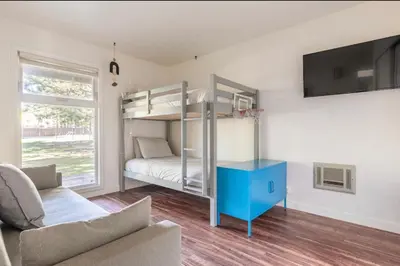 a living room with a bunk bed and a couch at Chateau Blanc 21 in Mammoth Lakes