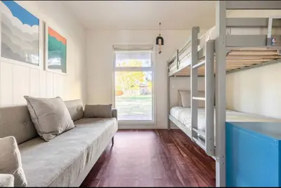 a living room with a couch and bunk beds at Chateau Blanc 21 in Mammoth Lakes