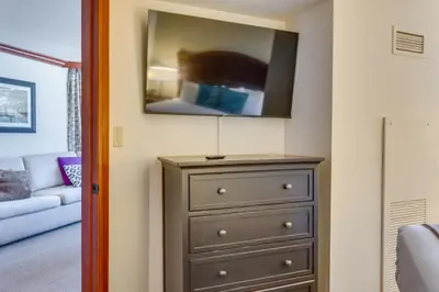 a room with a dresser with a tv on top at Palisades Tahoe Ski Getaway with Pool and Lift Access! in Olympic Valley
