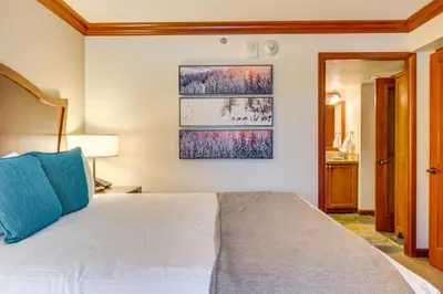 a bedroom with a bed with a blue pillow at Palisades Tahoe Ski Getaway with Pool and Lift Access! in Olympic Valley