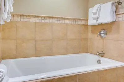 a bathroom with a bath tub in a room at Palisades Tahoe Ski Getaway with Pool and Lift Access! in Olympic Valley