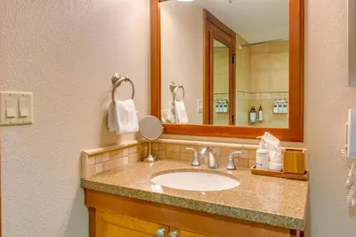 a bathroom with a sink and a mirror at Palisades Tahoe Ski Getaway with Pool and Lift Access! in Olympic Valley