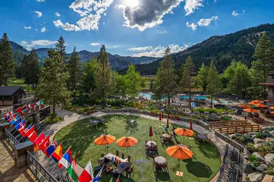 an aerial view of a resort with umbrellas at Palisades Tahoe Ski Getaway with Pool and Lift Access! in Olympic Valley