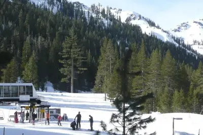 a group of people standing in the snow near a mountain at Ski-InandSki-Out! 2BR Condo with Resort Pools, Spa in Olympic Valley