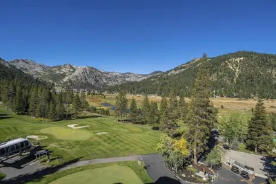 an aerial view of a golf course in the mountains at Walk to Palisades Tahoe Ski Lifts Mtn-View Condo in Olympic Valley