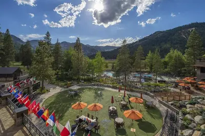 an aerial view of a resort with umbrellas at Walk to Palisades Tahoe Ski Lifts Mtn-View Condo in Olympic Valley