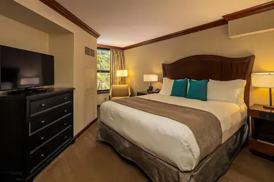 a bedroom with a large bed and a flat screen tv at Sweeping Views and Access to Slopes Everline Condo in Olympic Valley