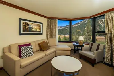 a living room with a couch and a table at Sweeping Views and Access to Slopes Everline Condo in Olympic Valley