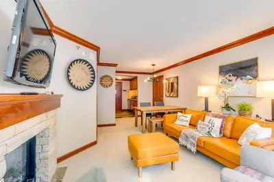a living room with a couch and a fireplace at Ski-InandSki-Out! 2BR Resort Condo with Pool, Hot Tub in Olympic Valley