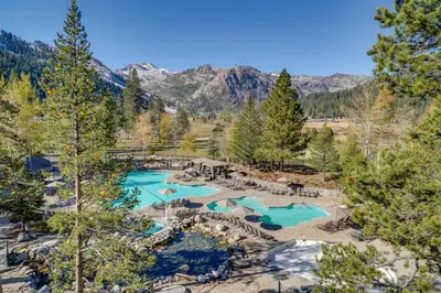 an aerial view of a resort with two pools at Ski-InandSki-Out! 2BR Resort Condo with Pool, Hot Tub in Olympic Valley