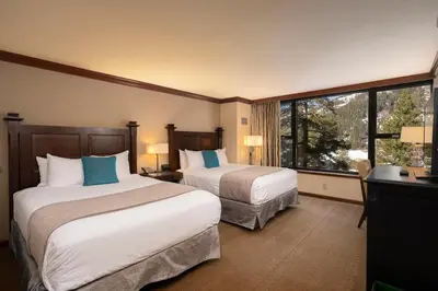 a hotel room with two beds and a window at Valley Vistas, Resort Perks Everline Studio Condo in Olympic Valley
