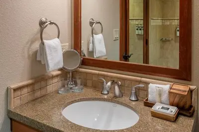 a bathroom with a sink and a mirror at Valley Vistas, Resort Perks Everline Studio Condo in Olympic Valley