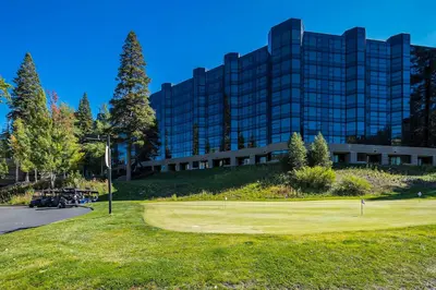 a golf course in front of a large building at Valley Vistas, Resort Perks Everline Studio Condo in Olympic Valley