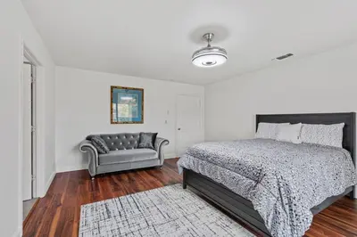 a bedroom with a bed and a couch in it at Spacious 6 BR • Patio + Deck • Sleeps 13 in Sacramento