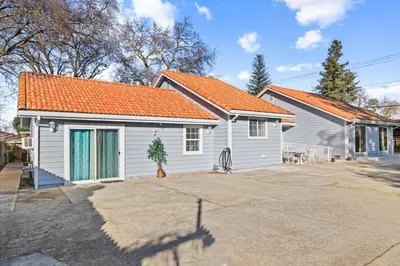 a white house with an orange roof at Spacious 6 BR • Patio + Deck • Sleeps 13 in Sacramento