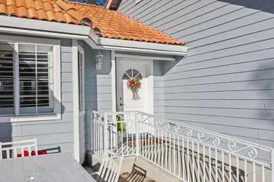 a house with a porch with a wreath on the door at Spacious 6 BR • Patio + Deck • Sleeps 13 in Sacramento