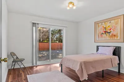a white room with a bed and a window at Spacious 6 BR • Patio + Deck • Sleeps 13 in Sacramento