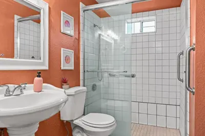 a bathroom with a toilet and a sink and a shower at Spacious 6 BR • Patio + Deck • Sleeps 13 in Sacramento
