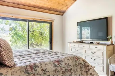 a bedroom with a bed and a tv and a window at Snowcreek 222 in Mammoth Lakes
